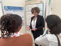 WOMAN SPEAKS TO 2 PEOPLE