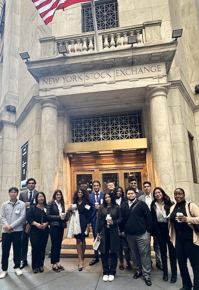 GROUP POSES IN FRONT OF NY STOCK EXCHANGE BLDG