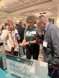 3 GATHER AT CONFERENCE TABLE