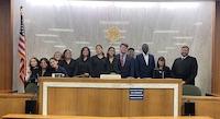 GROUP POSES WITH TRIAL JUDGE
