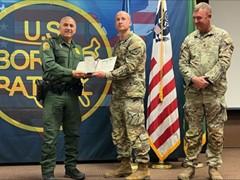 military men stand at awarding event