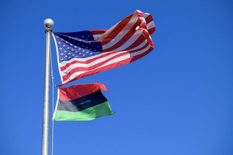 USA FLAG AND BLACK HISTORY FLAG ON POLE