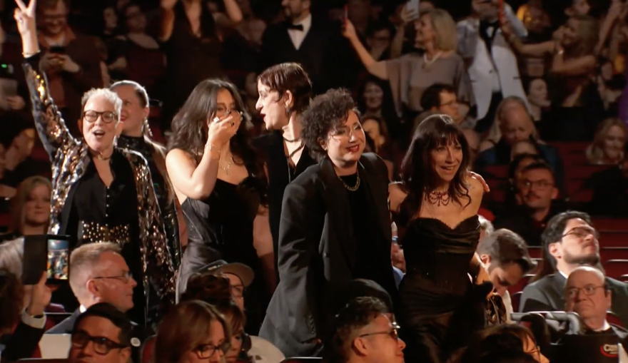 Martha Mooke at the Grammys with her arm in the air