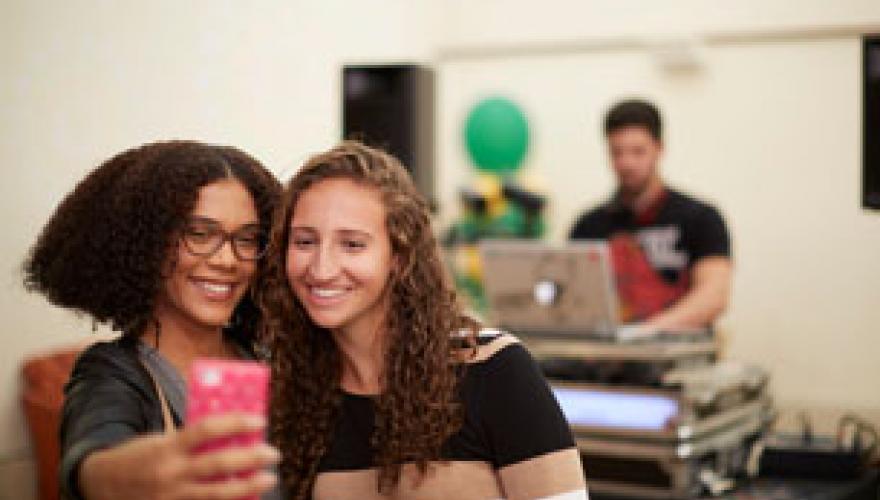 Students taking selfies at an event