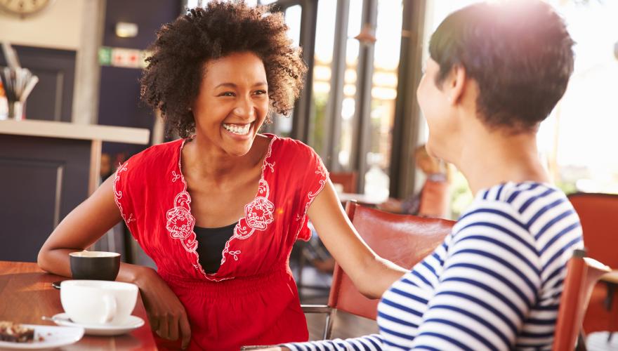 two women at table chatting