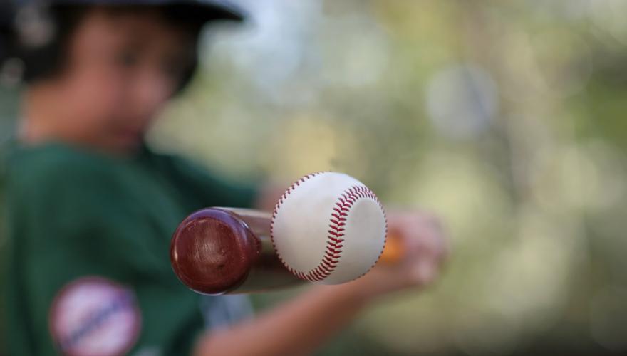 Kid hitting baseball