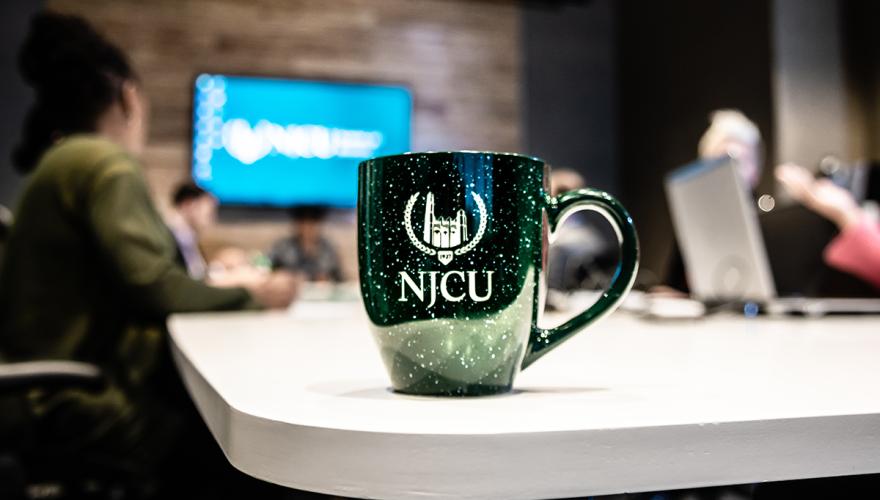 njcu coffee mug on table