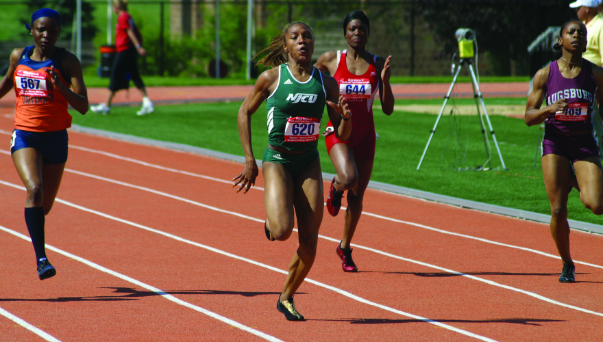 NJCU women's track runner in the lead.