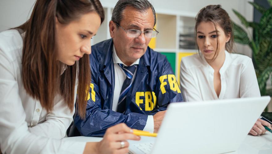 Two women with FBI worker