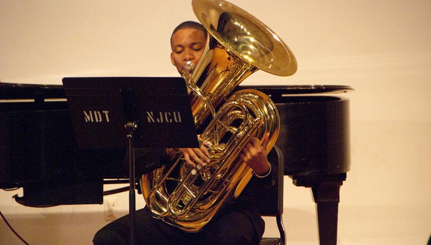 Student Playing a Tuba Onstage