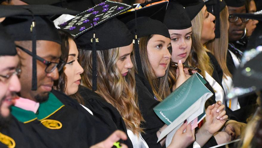 students in a row at commencement
