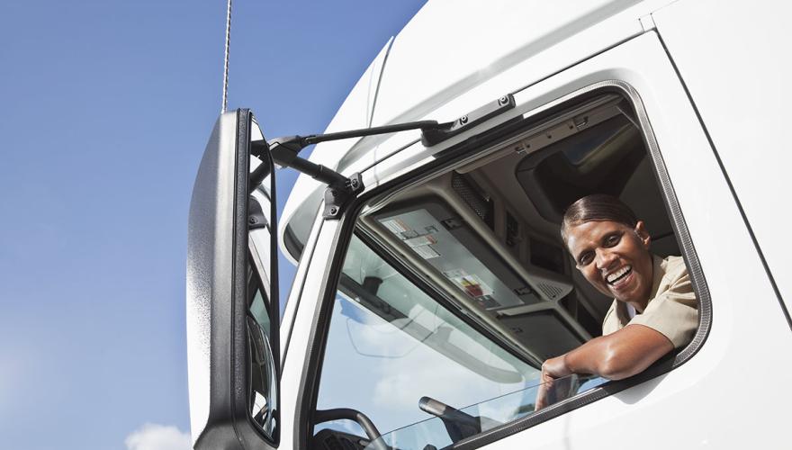 happy truck driver leaning out their window