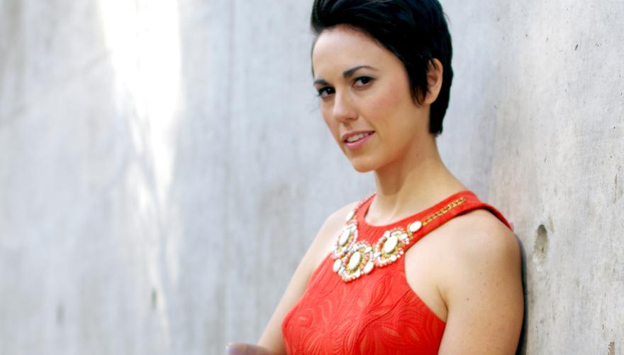 Gina Chavez in red dress holding string instrument