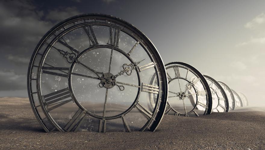 Row of metal clocks with different times on them