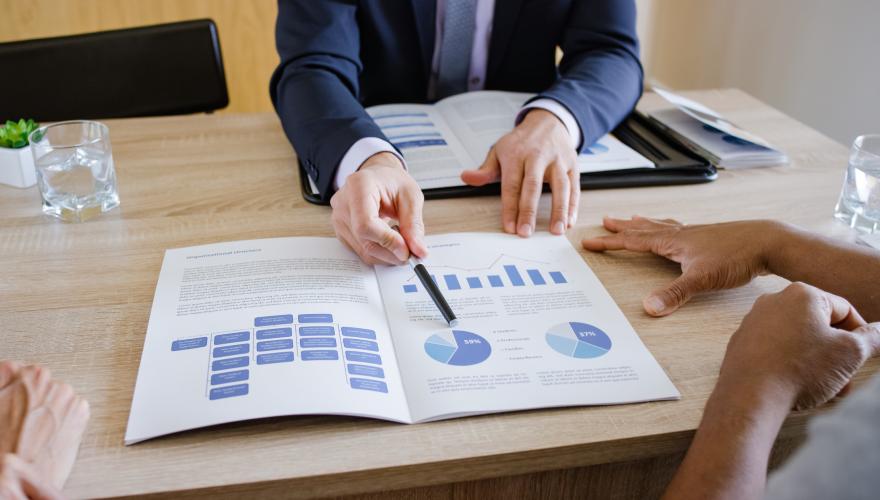 Certified Financial Planner showing investment options to couple