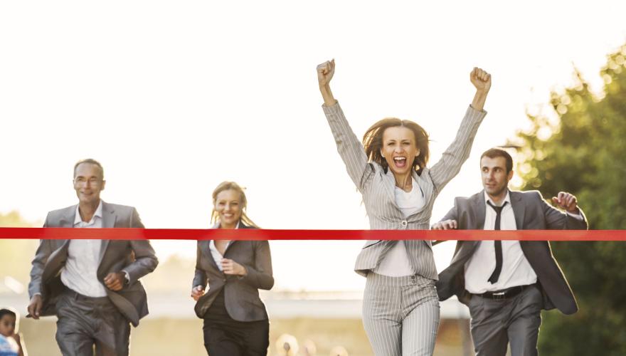 Business people running to finish, crossing red line. - stock photo GettyImages-170431775