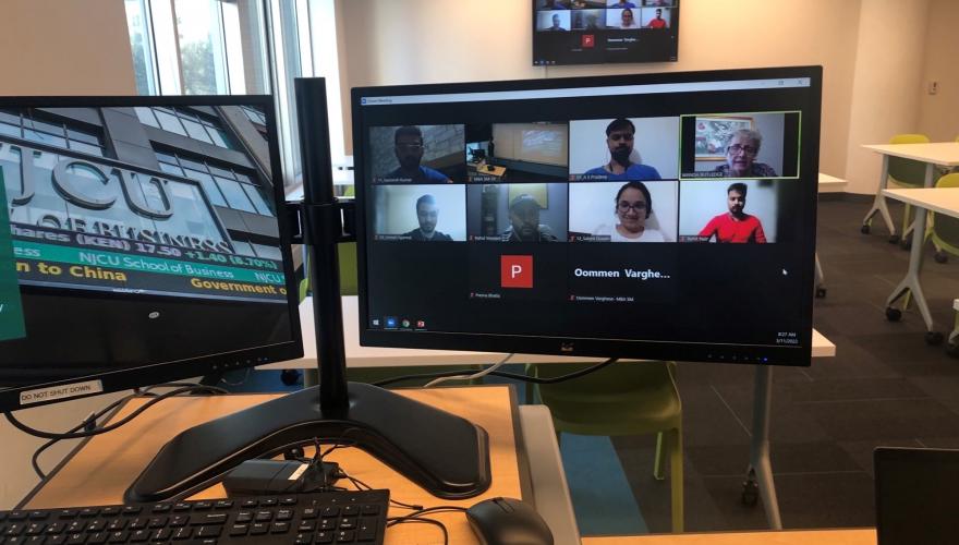 Computer monitor showing a zoom meeting for a sports management course. Participants are shown in a gallery view of attendees