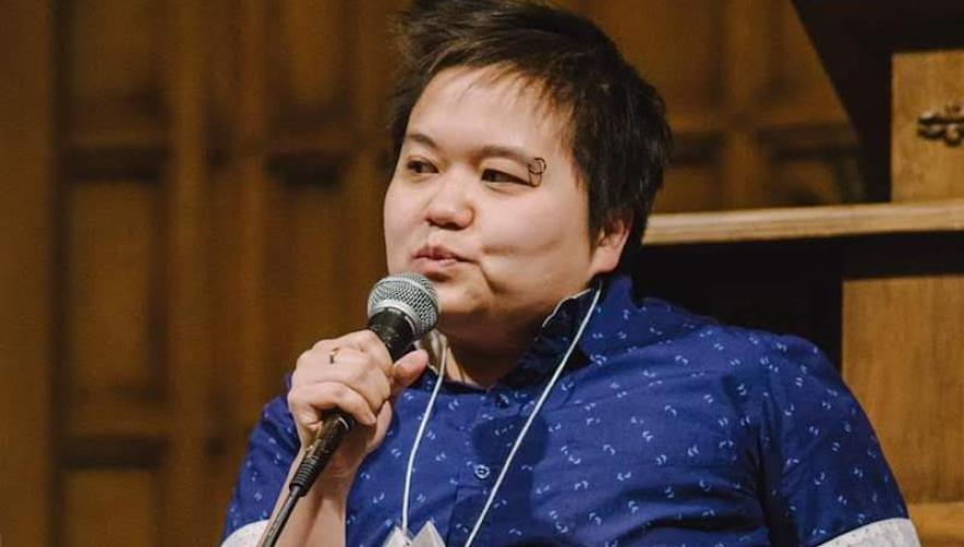 D. Eng HEADSHOT SEATED WITH MICROPHONE