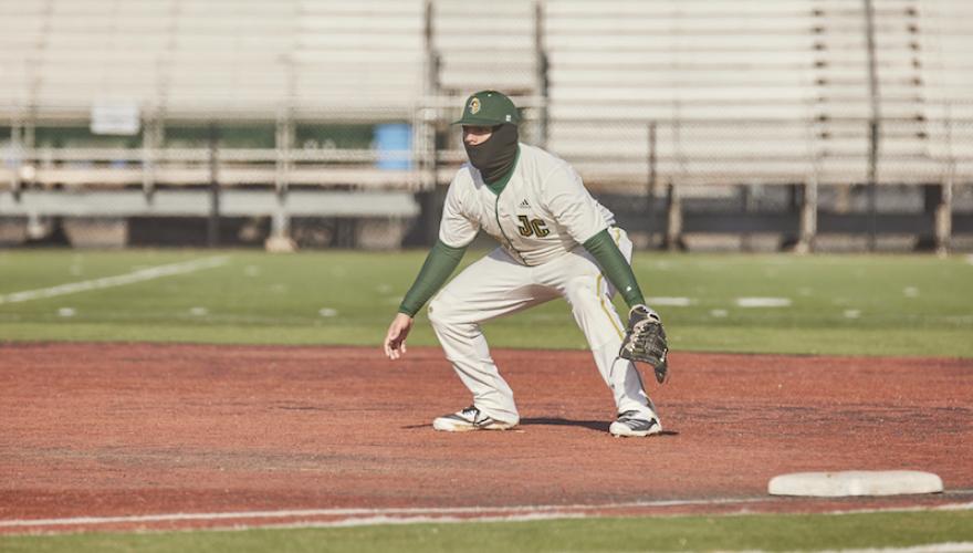 BASEBALL PLAYER WITH GLOVE MASKED AND BENDING
