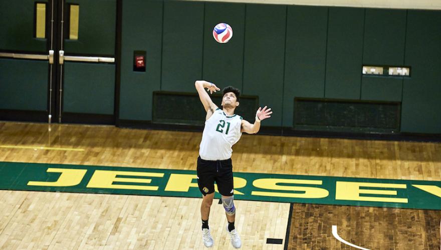 male swings at volleyball