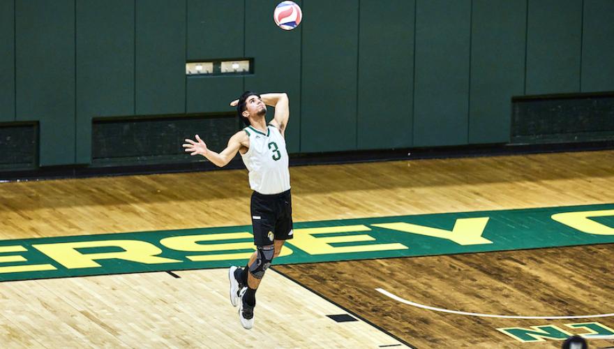 mens volleyball one player jumps with ball