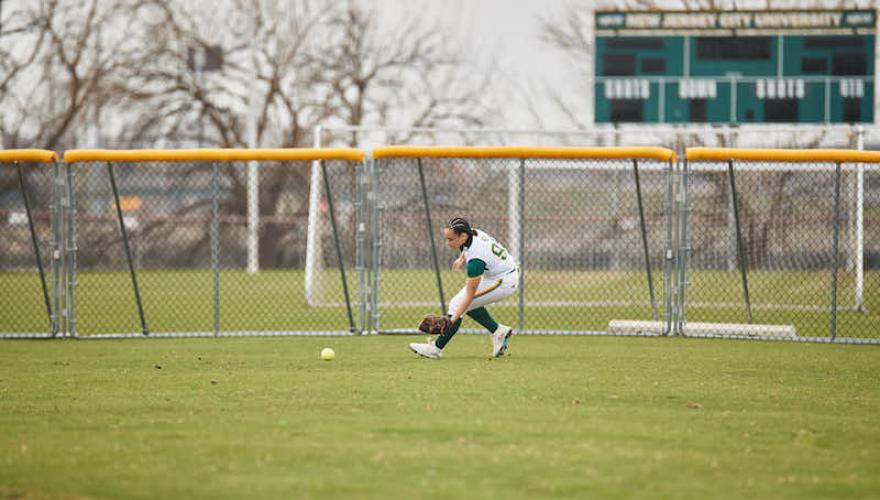 SOFTBALL PLAYER ON HOME YARD