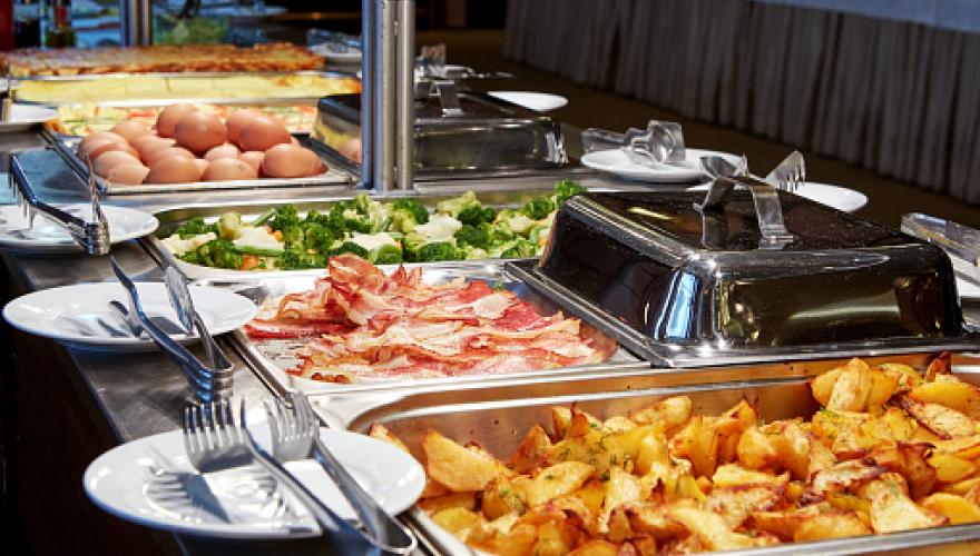 BUFFET FOOD WITH DISHES AND UTENSILS