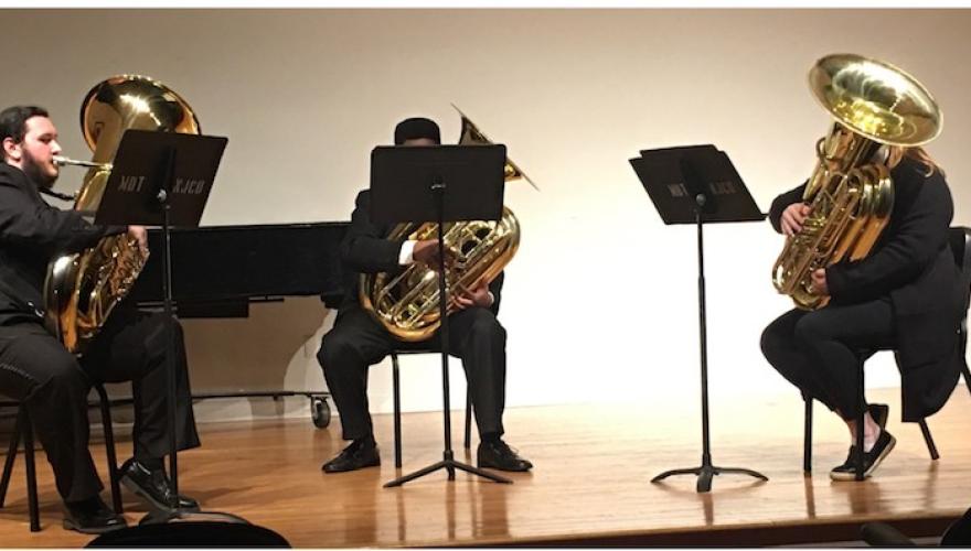 BRASS ENSEMBLE PLAYING WHILE SEATED