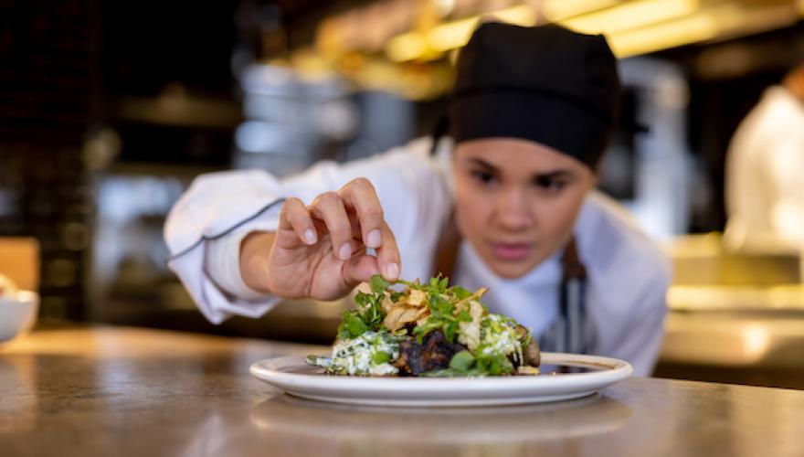 female chef with plate of food