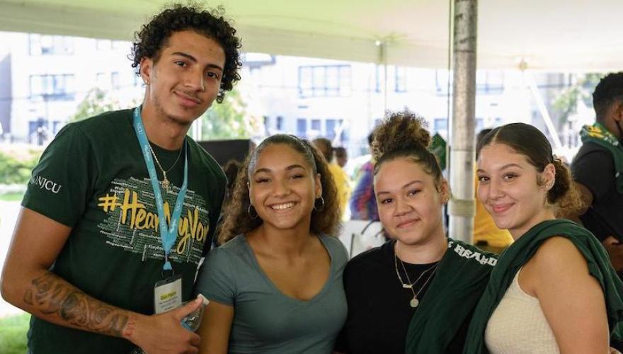 four students at homecoming event