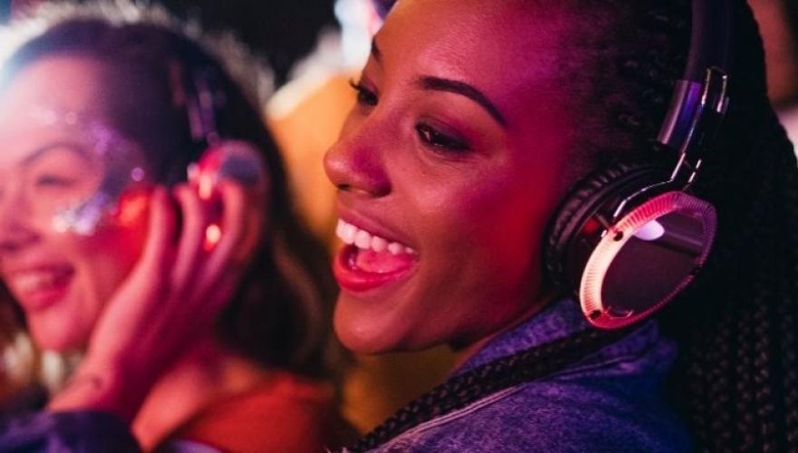 SMILING FEMALES WITH HEADPHONES