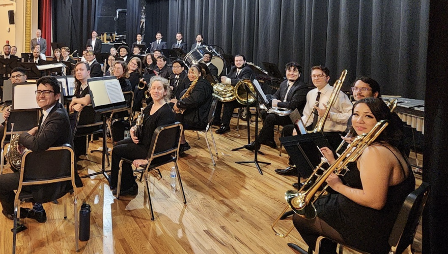 group shot of symphony, winds, and percussion team with their instruments in hand