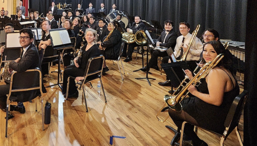 MUSICIANS SEATED LOOKING AHEAD