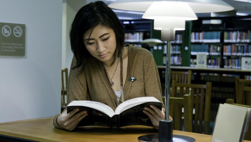 woman-reading-book-njcu-library-table