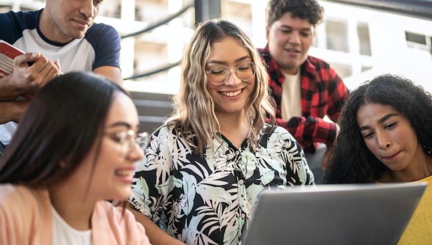 FIVE STUDENTS LOOK AT LAPTOP