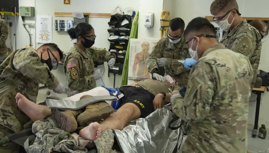 US ARMY MEDICAL TEAM AT WORK ON SOMEONE