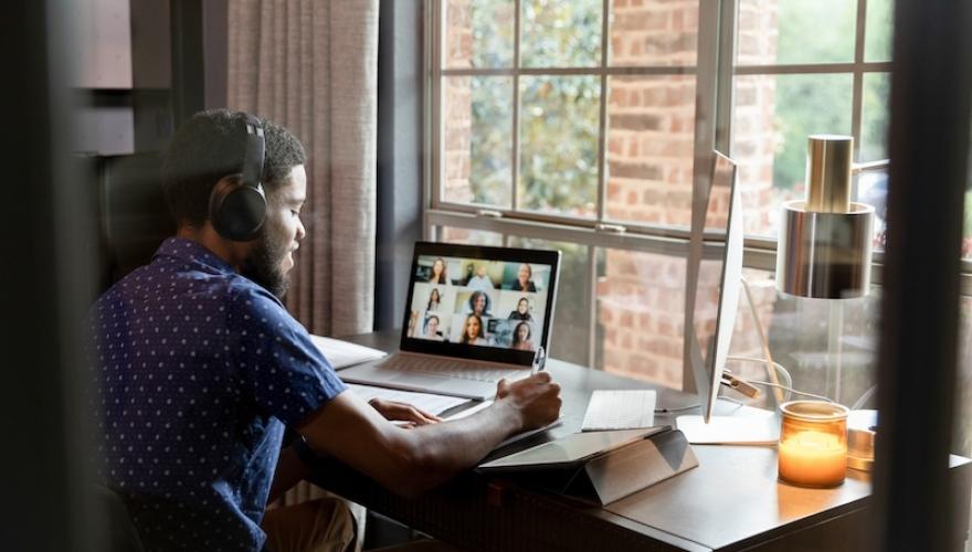 MAN WORKING REMOTE IN VIRTUAL MEETING