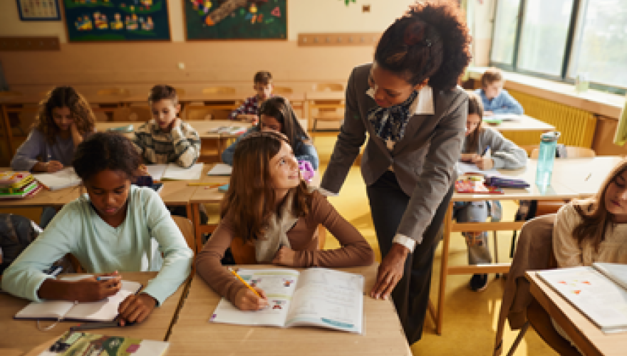 teacher talking to school kids on a class at elementary school