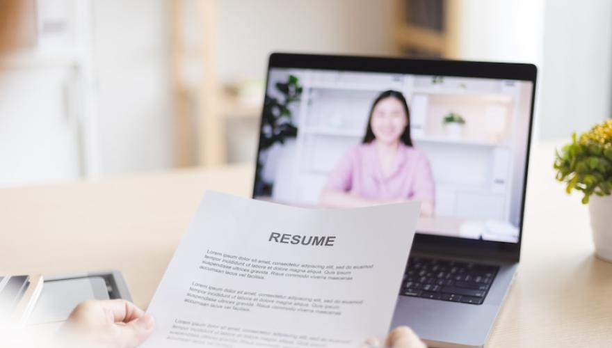 RESUME PRINTED NEAR LAPTOP