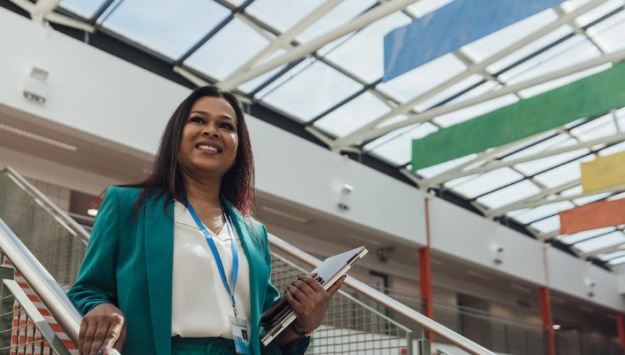 WOMAN SMILES ON LOBBY STEPS