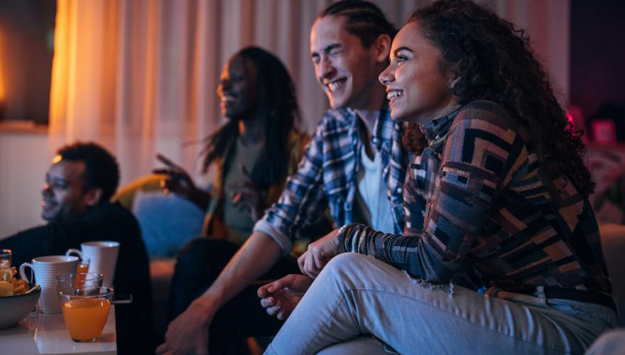FOUR SEATED PEOPLE LAUGHING