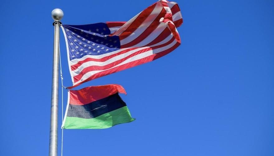 USA FLAG AND BLACK HISTORY FLAG ON POLE