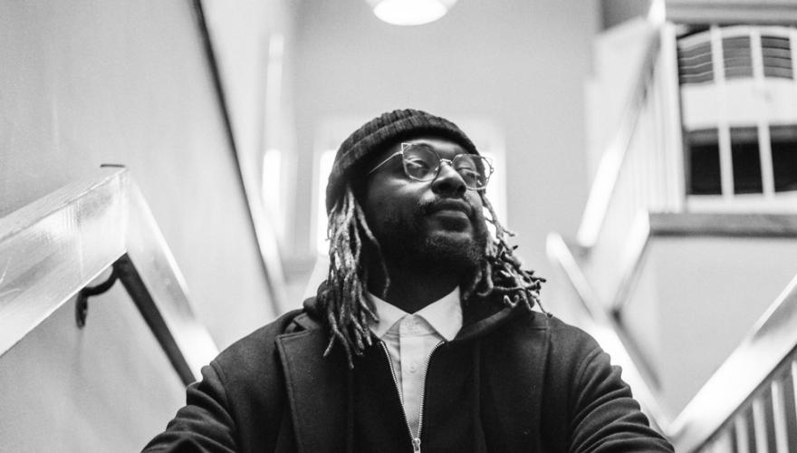 man sitting on stairs staring off into the distance
