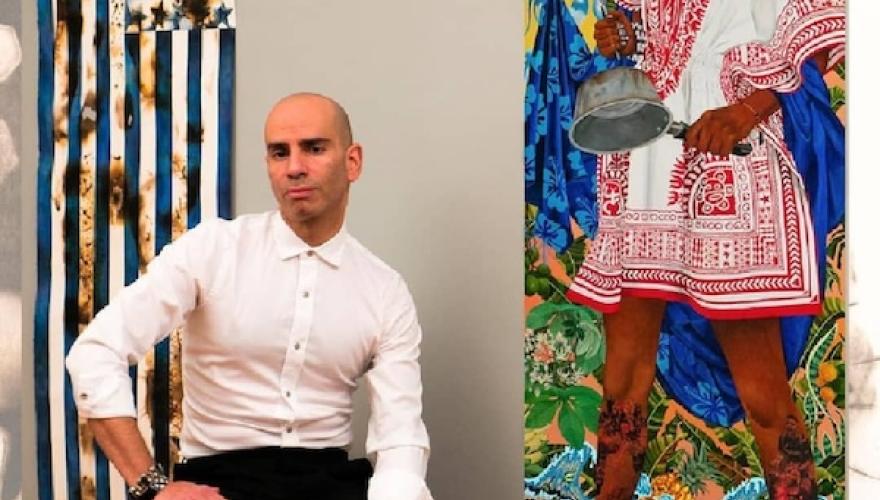 castro seated near art on wall