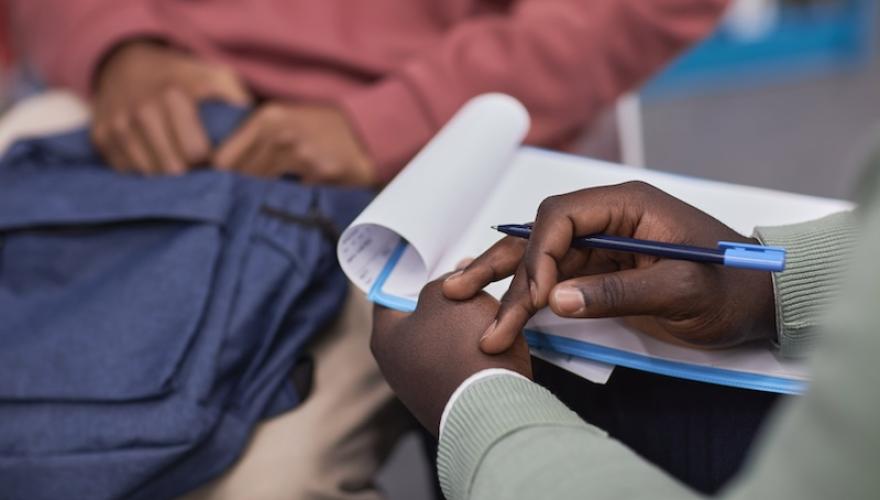 SEATED COUPLE HANDS AND CLIPBOARD SHOWN