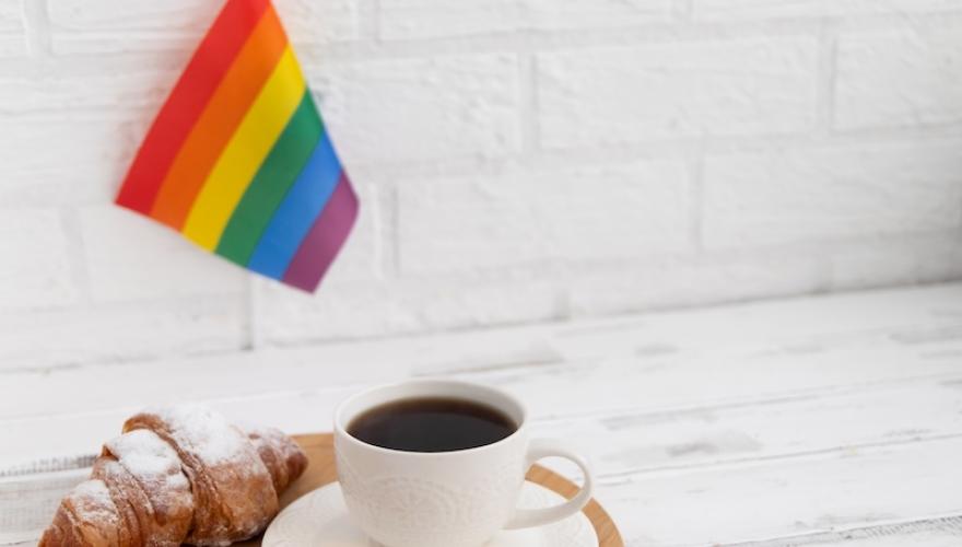 PRIDE FLAG ABOVE FOOD AND TEA