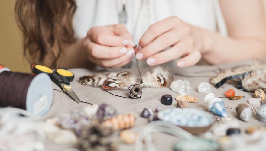 FEMALE HANDS MAKING JEWELRY