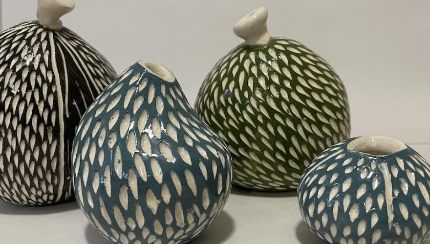four scultured pots