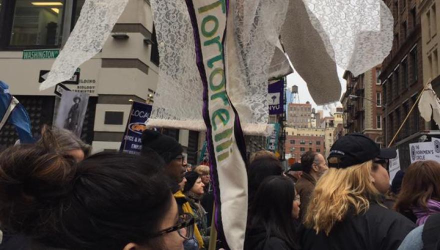 people at protest holding memorial signs
