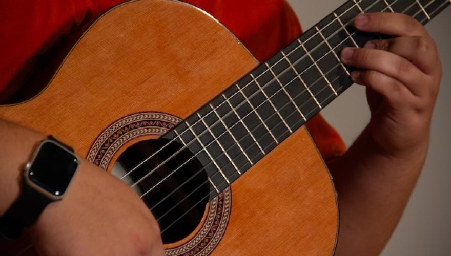 closeup of hands playing guitar